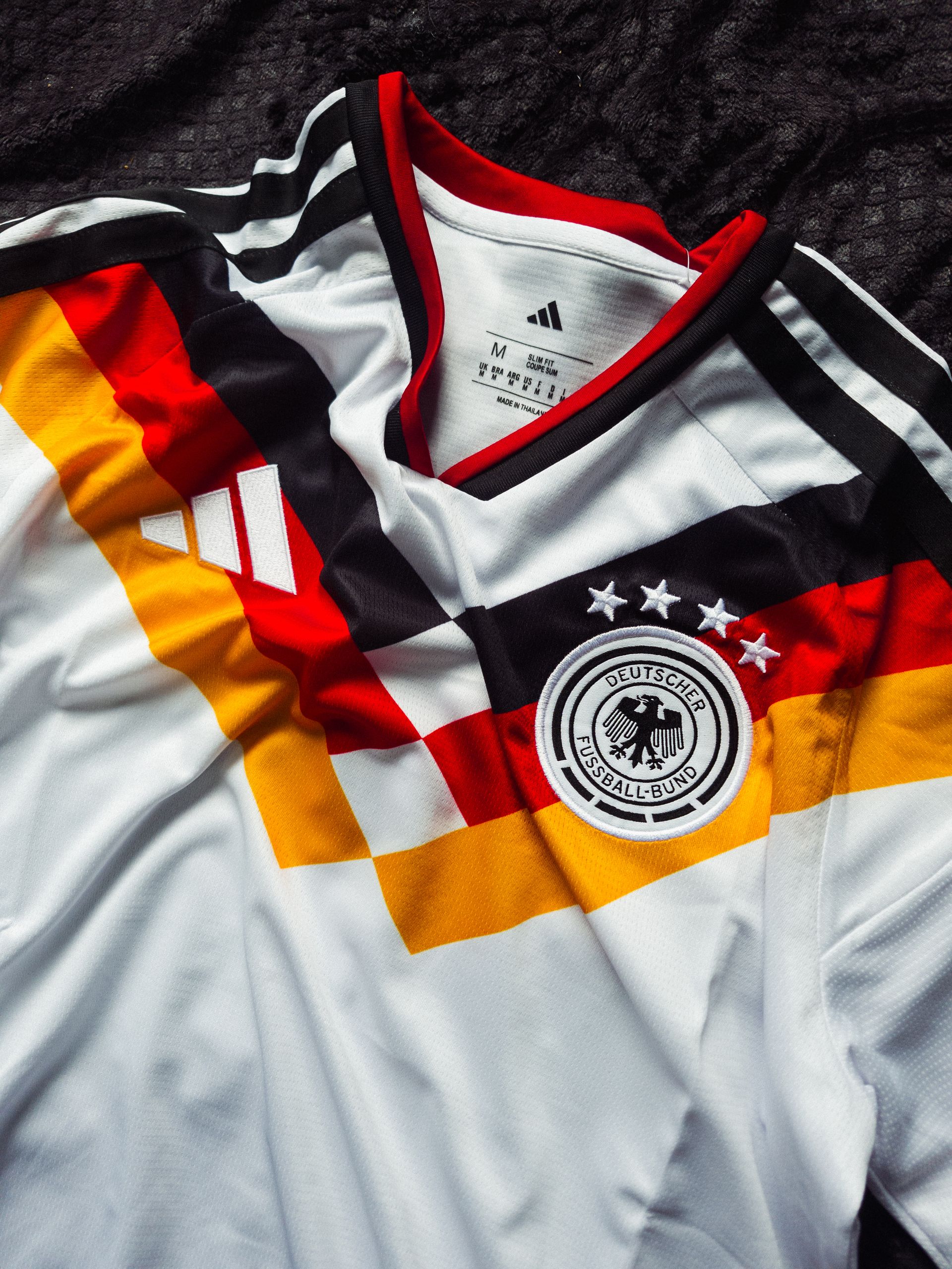Close-up of the Germany national football team jersey featuring vibrant colors and emblem.